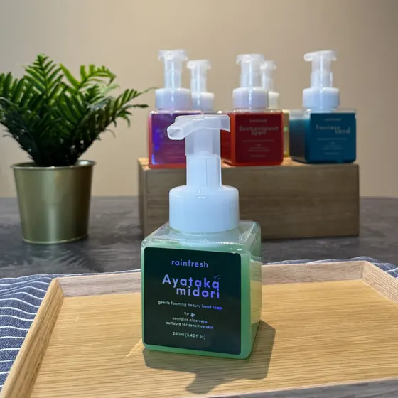 Ayataka Midori hand soap on a wooden tray, with more scents behind