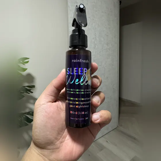 Sleep Well 100ml bottle held in one hand — small enough for an overnight bag
